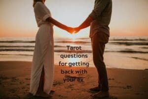 Couple holding hands on the beach at sunset with caption: "Tarot questions for getting back with your ex"